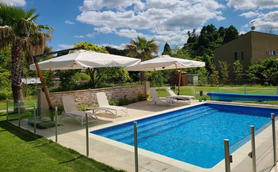 大型パラソルとデッキチェアを備えたマジラインプールの施工事例